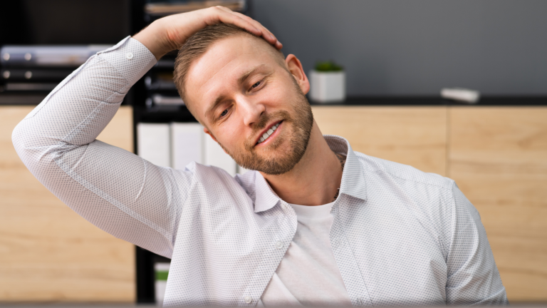 man stretching at his desk using the stretches his chiropractor gave him in fairfax, va